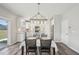 Bright kitchen and dining area with modern lighting, stainless steel appliances, and hardwood floors at 256 Summer Ranch Dr, Fuquay Varina, NC 27526