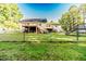 Spacious backyard with multiple decks and stairs, all surrounded by a chain-link fence for added security at 2619 Steel Bridge Rd, Sanford, NC 27330