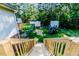 Well-maintained backyard with lush green grass, shed, chain link fence, and deck access at 2619 Steel Bridge Rd, Sanford, NC 27330