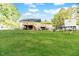 Expansive backyard featuring a deck, playhouse, and a secure chain-link fence, perfect for outdoor activities at 2619 Steel Bridge Rd, Sanford, NC 27330