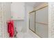 Bathroom features a white toilet, storage cabinet and shower with sliding glass doors at 2619 Steel Bridge Rd, Sanford, NC 27330