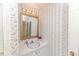 Bathroom with a framed mirror, vanity with white cabinets, sink and a light fixture at 2619 Steel Bridge Rd, Sanford, NC 27330