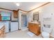 Bright bathroom featuring a single shower stall, washer, dryer, sink, toilet and ample storage at 2619 Steel Bridge Rd, Sanford, NC 27330