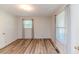 Bedroom with wood floor, two windows with curtains and a door to the hallway at 2619 Steel Bridge Rd, Sanford, NC 27330