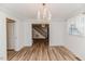 Dining room featuring a crystal chandelier, wood floors, and access to staircase at 2619 Steel Bridge Rd, Sanford, NC 27330