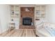 Cozy fireplace with brick surround, built-in shelving, and a decorative chair at 2619 Steel Bridge Rd, Sanford, NC 27330