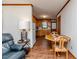 View of kitchen from the sitting area, featuring wood cabinets, appliances, and a dining table at 2619 Steel Bridge Rd, Sanford, NC 27330