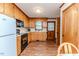 Classic kitchen featuring wood cabinets, a white refrigerator, and wood-look flooring at 2619 Steel Bridge Rd, Sanford, NC 27330