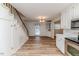 Open-concept kitchen and dining area with stainless steel appliances and staircase at 2619 Steel Bridge Rd, Sanford, NC 27330