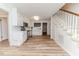 Eat-in kitchen featuring stainless steel appliances, white cabinets and convenient access to the staircase at 2619 Steel Bridge Rd, Sanford, NC 27330