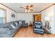 Open living area featuring cozy furniture, wood flooring and trim, and a ceiling fan at 2619 Steel Bridge Rd, Sanford, NC 27330