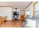 Comfortable living room featuring a TV, sofa, a wood trimmed front door, and wood floors at 2619 Steel Bridge Rd, Sanford, NC 27330