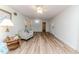 Bright living room boasts hardwood flooring, neutral walls, and a view into the kitchen at 2619 Steel Bridge Rd, Sanford, NC 27330