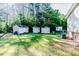 Lawn featuring multiple storage sheds, providing ample space for outdoor equipment and storage at 2619 Steel Bridge Rd, Sanford, NC 27330