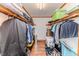 Spacious walk-in closet features wooden shelves and ample storage for clothing and other personal items at 2619 Steel Bridge Rd, Sanford, NC 27330