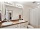 Bathroom featuring double sinks, granite countertops, shower with white shower curtain, and a toilet at 270 Wembley Dr, Clayton, NC 27527