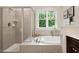 Elegant bathroom featuring a tiled shower and soaking tub at 270 Wembley Dr, Clayton, NC 27527