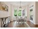 Bright dining area with a round table, four chairs, and large windows overlooking the yard at 270 Wembley Dr, Clayton, NC 27527