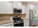 Modern kitchen with granite countertops, stainless steel appliances, and white cabinetry at 270 Wembley Dr, Clayton, NC 27527