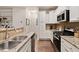 Modern kitchen with granite countertops, stainless steel appliances, and ample cabinet space at 270 Wembley Dr, Clayton, NC 27527