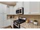 Well-equipped kitchen featuring granite countertops, stainless steel appliances, and white cabinetry at 270 Wembley Dr, Clayton, NC 27527