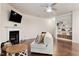 Cozy living room with a fireplace, mounted TV, hardwood floors, and built-in shelving at 270 Wembley Dr, Clayton, NC 27527