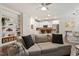 Open-concept living room with a sofa, hardwood floors, and a view into the kitchen at 270 Wembley Dr, Clayton, NC 27527