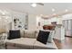 Open-concept living room with a sofa, hardwood floors, and a view into the kitchen at 270 Wembley Dr, Clayton, NC 27527