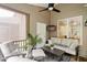 Inviting screened-in patio featuring cozy seating, a ceiling fan, and outdoor decor at 270 Wembley Dr, Clayton, NC 27527