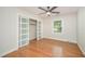Bedroom with hardwood flooring, a ceiling fan, and a closet with sliding doors at 2800 Glen Burnie Dr, Raleigh, NC 27607