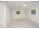 A bright bedroom featuring neutral walls, carpet, two large windows, and a closet at 2800 Glen Burnie Dr, Raleigh, NC 27607