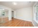 Bedroom with hardwood flooring and closet with mirrored doors at 2800 Glen Burnie Dr, Raleigh, NC 27607