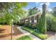 Charming brick home featuring manicured landscaping and walkway to the front door at 2800 Glen Burnie Dr, Raleigh, NC 27607