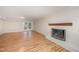 Living room with a white-painted brick fireplace and wood-look flooring at 2800 Glen Burnie Dr, Raleigh, NC 27607