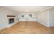 Living room featuring wood-look floors, a brick fireplace, and built-in shelves at 2800 Glen Burnie Dr, Raleigh, NC 27607