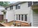 This backyard features a private wooden deck with outdoor seating and access to the house through French doors at 2822 Pickett Rd # 173, Durham, NC 27705
