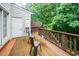 Cozy wooden deck area with chairs, a small table, and a charming view, perfect for relaxing outdoors at 2822 Pickett Rd # 173, Durham, NC 27705