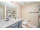 Bathroom featuring grey vanity with granite counters and floral shower curtain at 2822 Pickett Rd # 173, Durham, NC 27705