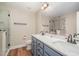 Bathroom featuring double sinks with granite counters and a glass shower at 2822 Pickett Rd # 173, Durham, NC 27705