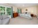 Bright bedroom features large windows, a ceiling fan, and neutral carpeting at 2822 Pickett Rd # 173, Durham, NC 27705