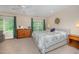 Bright bedroom with natural light, neutral carpeting, and ceiling fan at 2822 Pickett Rd # 173, Durham, NC 27705