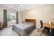 Bedroom features ceiling fan, large window, desk and a rocking chair at 2822 Pickett Rd # 173, Durham, NC 27705