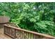 View from the wooden deck showcasing the lush, green surroundings and creating a serene outdoor space at 2822 Pickett Rd # 173, Durham, NC 27705
