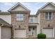 Attractive townhouse with stone facade, neat landscaping, and attached garages at 2822 Pickett Rd # 173, Durham, NC 27705