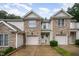 Charming townhome with stone accents, attached garage, and manicured lawn at 2822 Pickett Rd # 173, Durham, NC 27705