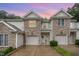 Charming townhome with stone accents, attached garage, and manicured lawn at 2822 Pickett Rd # 173, Durham, NC 27705