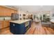 Open floor plan featuring a modern kitchen, dining area, sliding glass doors, and luxury vinyl plank flooring at 2822 Pickett Rd # 173, Durham, NC 27705