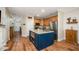 Modern kitchen with a center island, stainless steel appliances, and luxury vinyl plank flooring at 2822 Pickett Rd # 173, Durham, NC 27705