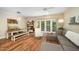 Open floor plan featuring a dining area, sliding glass doors, luxury vinyl plank flooring, and a gray sofa at 2822 Pickett Rd # 173, Durham, NC 27705
