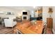 Open floor plan featuring a modern kitchen, dining area, fireplace, and luxury vinyl plank flooring at 2822 Pickett Rd # 173, Durham, NC 27705